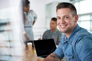 Homem de negócios casualmente no escritório sorrindo