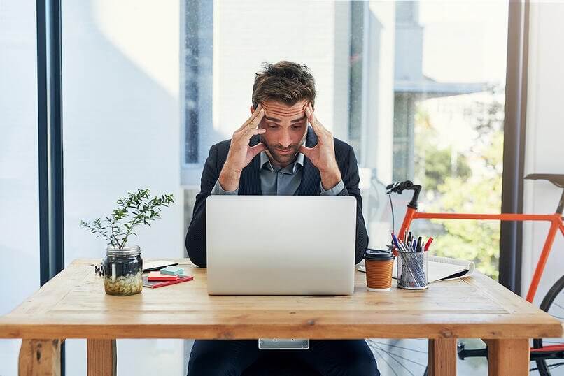 homem preocupado na frente do notebook 